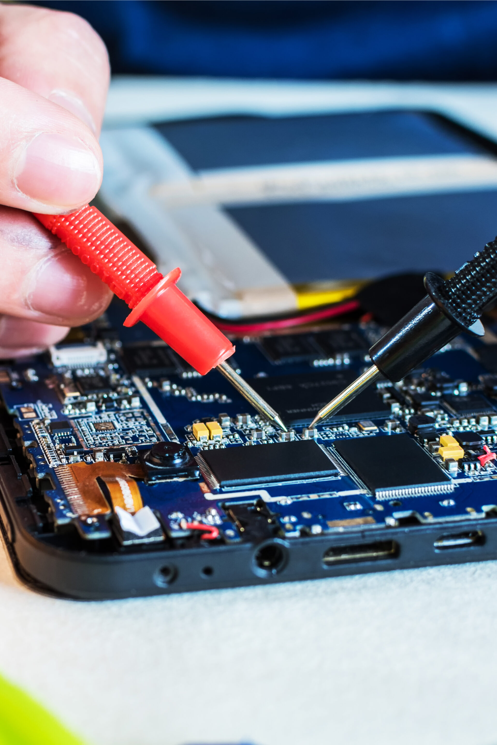Why Not Fix using an amp meter to check the pins on a phone motherboard - Phone & electronic repair in Ashford completed by specialists at Why Not Fix
