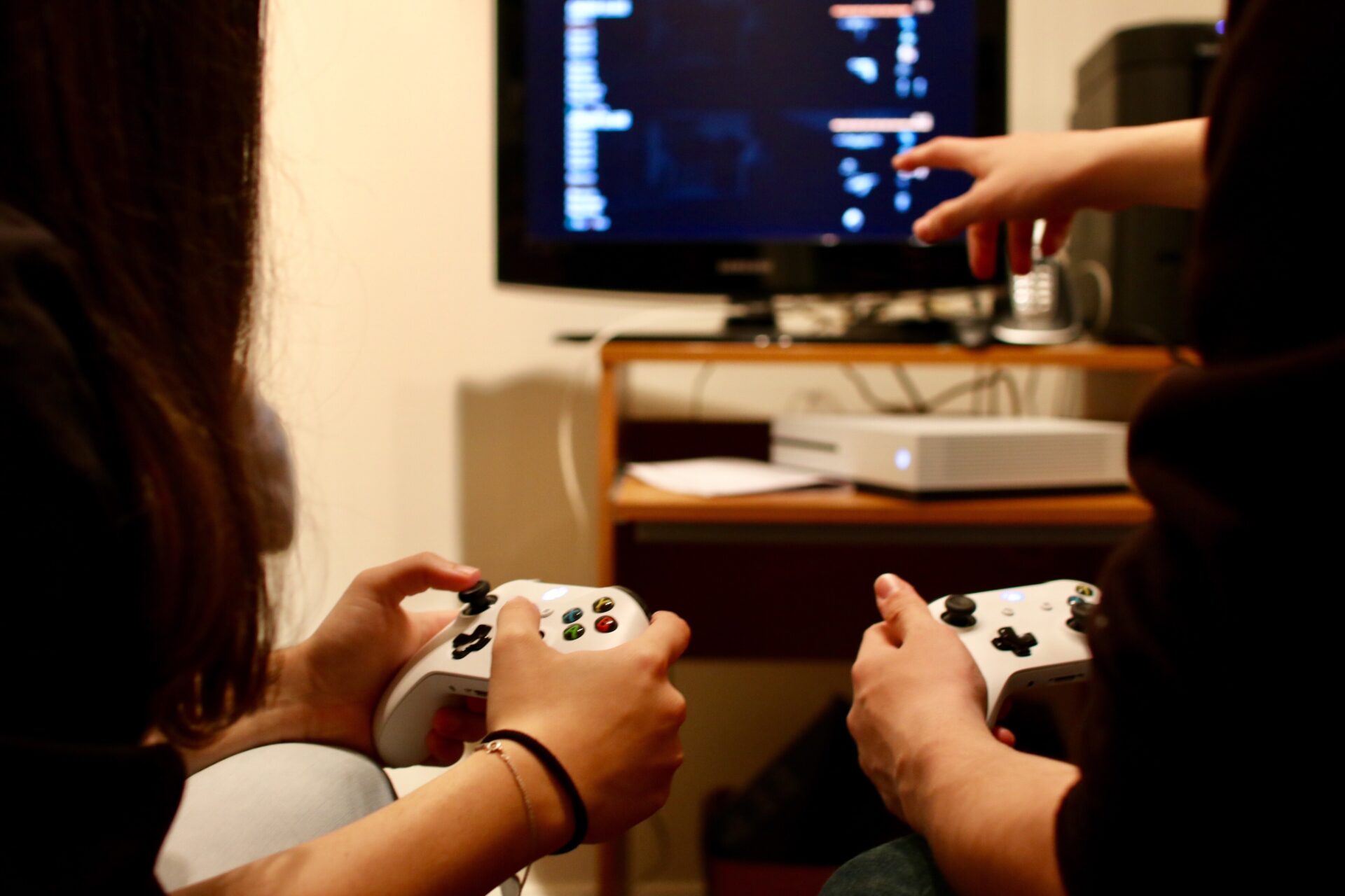 Person using a console controller to play a video game on a console both repaired by Why Not Fix | Console repair in Dover completed by specialists at Why Not Fix