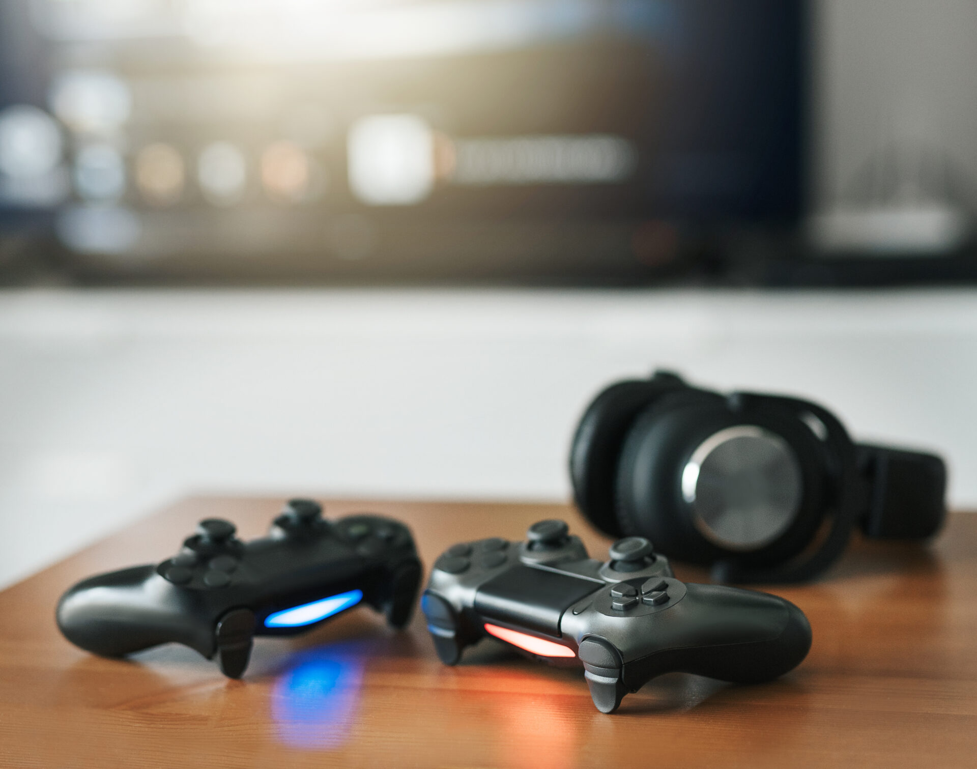 Console controllers and headphones resting on a table after being repaired by Why Not Fix | Console repair in Dover completed by specialists at Why Not Fix